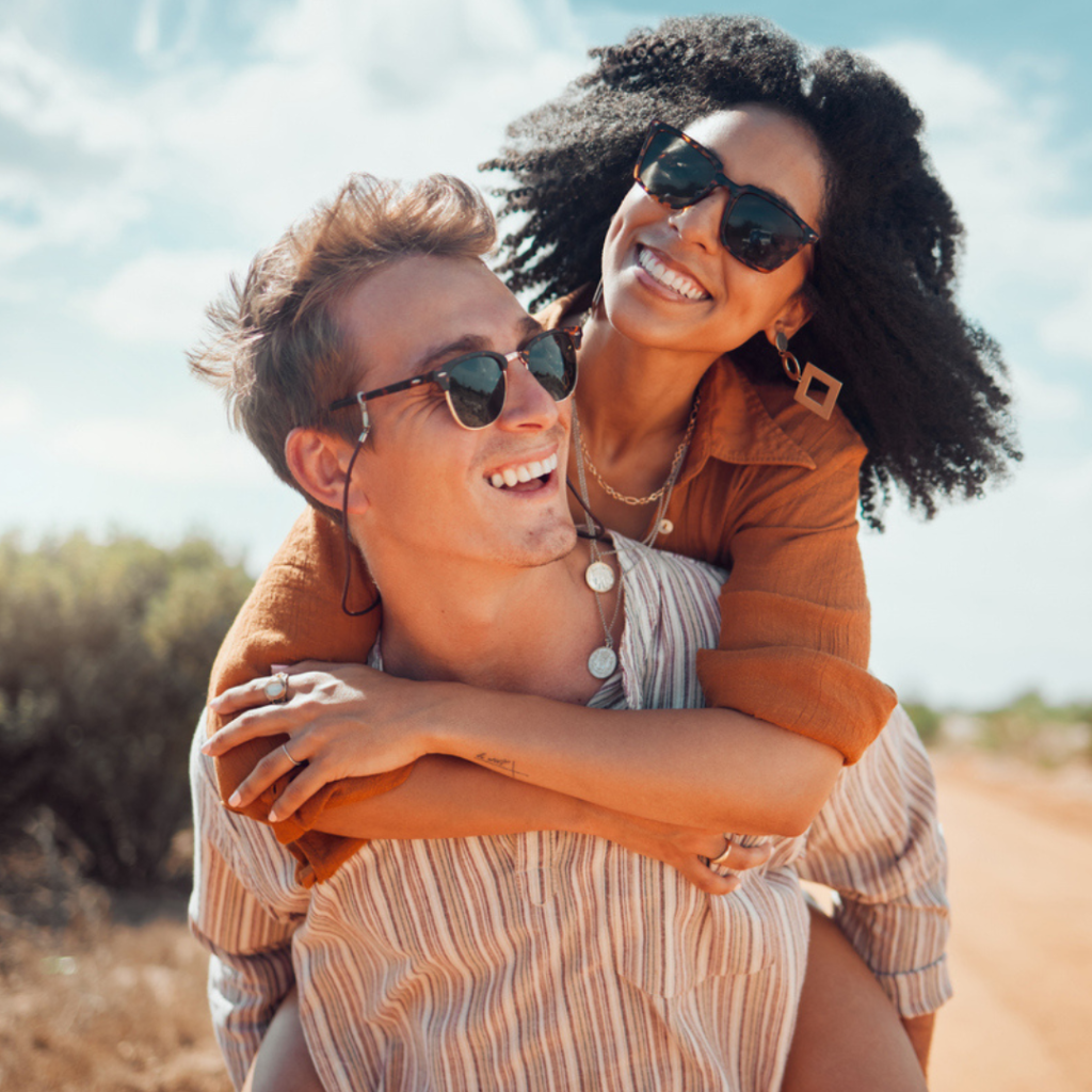 Smiling couple wearing sunglasses - cosmetic dentistry is available in Oviedo at Alafaya Family Dentistry!